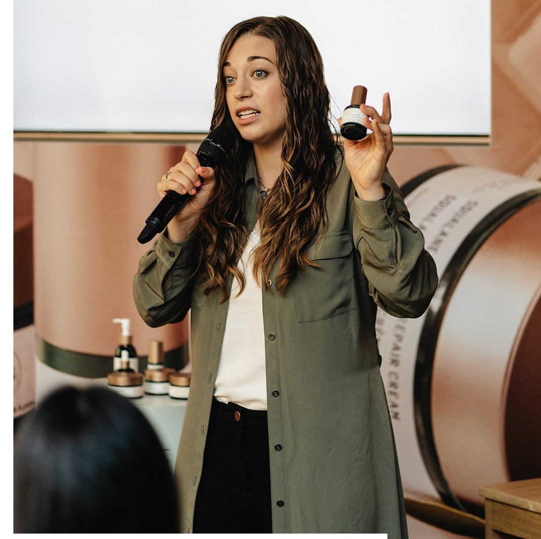 McKenzie speaking at a Biossance brand event